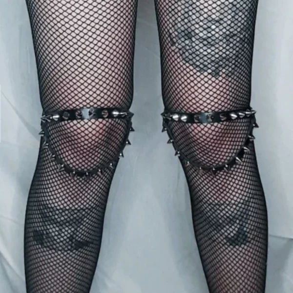 Jarretières Cloutées à Double Lanière en Cuir au-dessus de collants résille sur les Genoux.