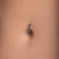 Femme avec Piercing Nombril Clicker Titane Noir à Zircons Sertis.