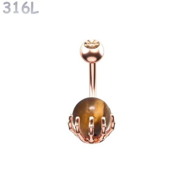 Piercing Nombril Sphère Œil de Tigre Sertie d’une Main Squelettique Acier 316L Or Rose PVD Piercing Nombril Sphère Œil de Tigre Sertie d’une Main Squelettique Acier 316L Or Rose PVD.
