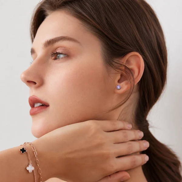 Femme avec Boucles d’Oreilles Argentées aux Améthystes Violettes Femme avec Boucles d’Oreilles Argentées aux Améthystes Violettes.