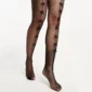 Collant Résille Noir orné de Sept Nœuds Ruban en Satin.