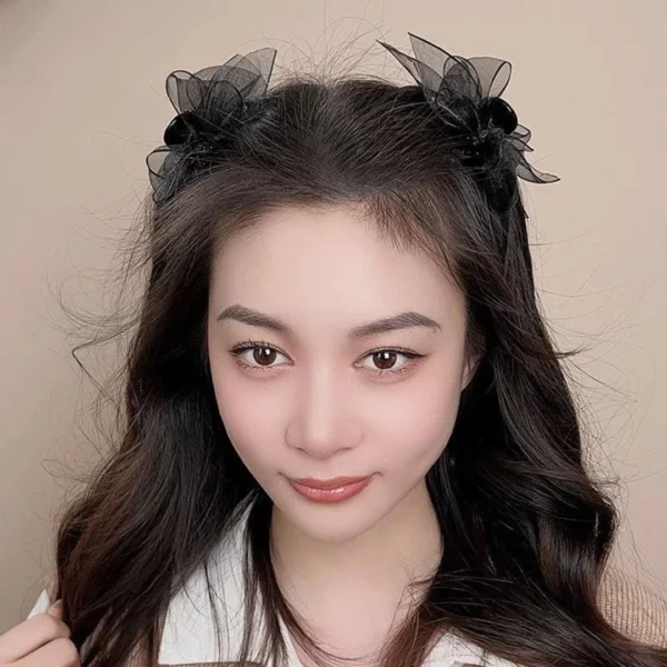 Femme avec deux Pinces Crabe ornées de Nœuds Papillon en Organza Noir.