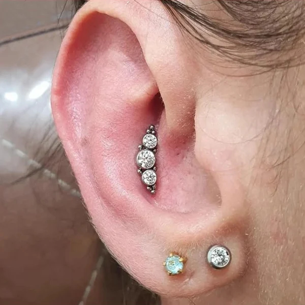 Femme avec un Piercing Labret Titane Harmonie de Zircons & Billes au Conch Interne Femme avec un Piercing Labret Titane Harmonie de Zircons & Billes au Conch Interne.