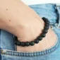 Femme avec Bracelet de Perles en Pierre de Lave Noir Mat 10 mm au Poignet.