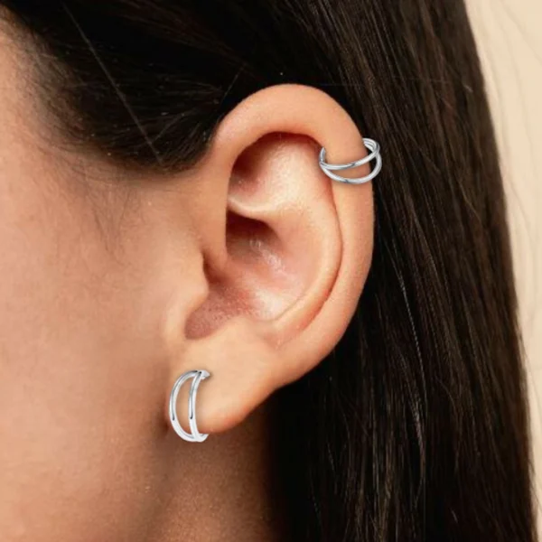 Femme avec Piercing Double Anneau Clicker Titane - Ø 8 mm au lobe et à l'hélix Femme avec Piercing Double Anneau Clicker Titane - Ø 8 mm au lobe et à l'hélix.